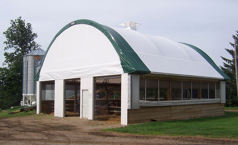 Naturally ventilated fabric structure for housing calves.