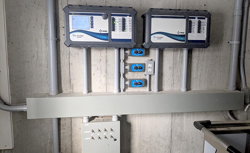 Commandes d'automatisation des systèmes de ventilation dans une grange, montées sur un mur.