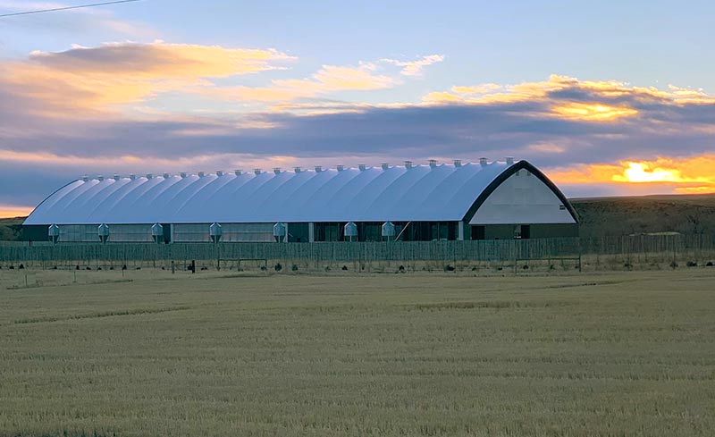 A fabric covered structure with a natural ventilation system.