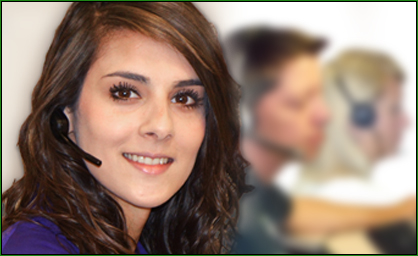 A customer service representative smiling with a headset on and two others in the background.