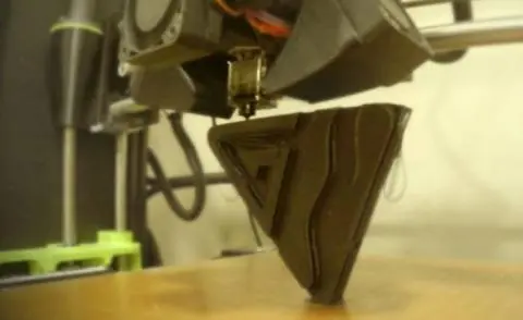 A 3D printer creating the Canarm logo.