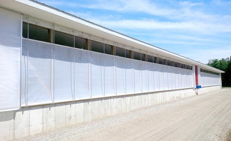 A small opening in a curtain system allows fresh air in on a cool spring day.