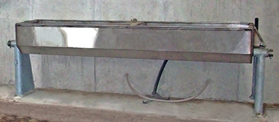 A stainless steel water trough.