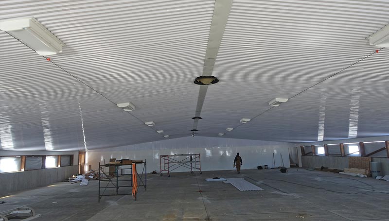 Ceiling inlets and chimneys with fans installed in a new swine barn under construction.